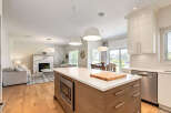 Experience modern living in this open-concept home featuring a sleek kitchen island with a built-in microwave and ample storage.