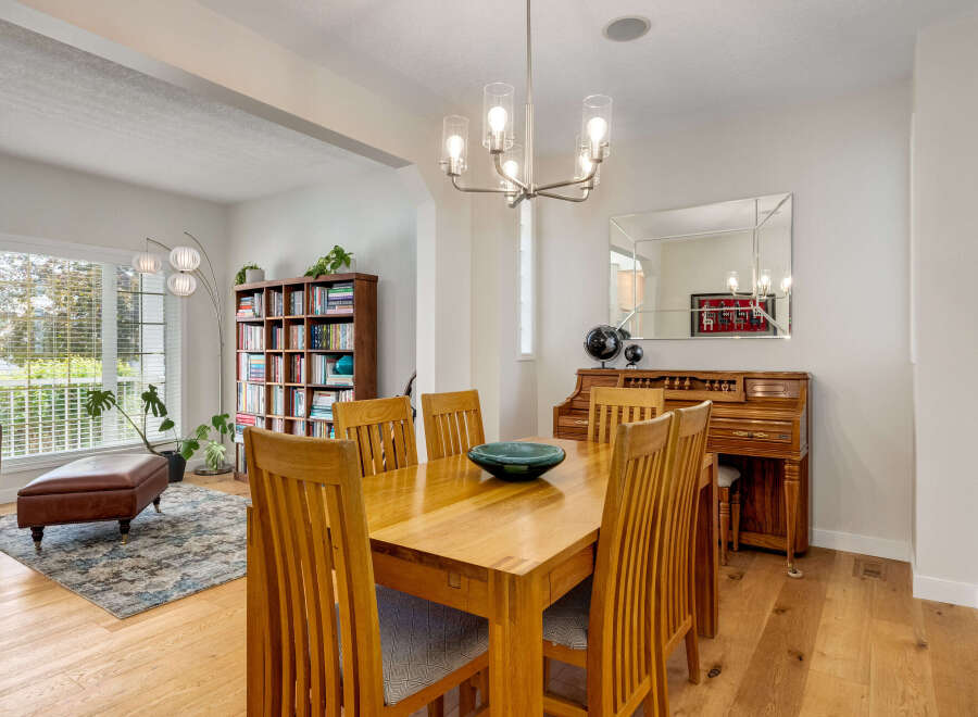 This inviting dining room features a warm oak dining table with four chairs, perfect for family meals.