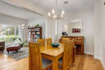 This inviting dining room features a warm oak dining table with four chairs, perfect for family meals.