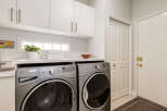 This laundry room features a modern Whirlpool washer and dryer set, perfect for handling all your laundry needs.