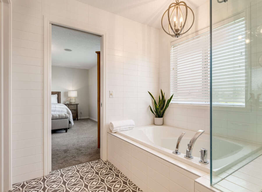 Indulge in relaxation in this luxurious bathroom featuring a spacious soaking tub, perfect for unwinding after a long day.