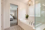 Indulge in relaxation in this luxurious bathroom featuring a spacious soaking tub, perfect for unwinding after a long day.