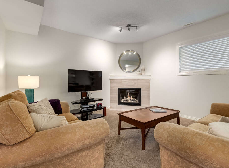 Cozy up by the modern gas fireplace in this inviting living room, perfect for relaxing evenings.