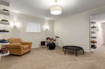 This versatile room offers a perfect blend of entertainment and relaxation, featuring a comfortable armchair, a drum set for musical exploration, and a mini-trampoline for active fun.
