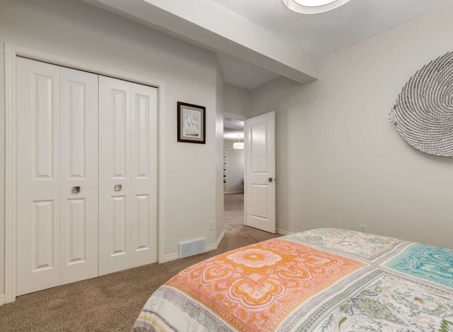 Discover comfort and style in this inviting bedroom, featuring a large closet with bi-fold doors for ample storage.
