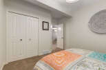 Discover comfort and style in this inviting bedroom, featuring a large closet with bi-fold doors for ample storage.