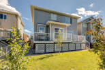 Enjoy outdoor living on this spacious deck with white railings, perfect for entertaining or relaxing.