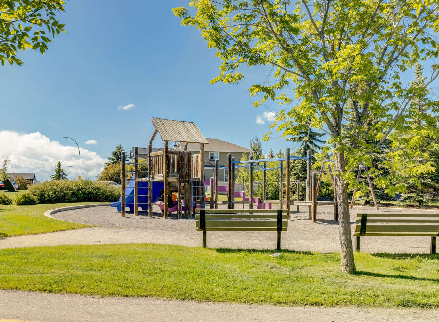 Enjoy outdoor fun in this vibrant community playground, featuring a multi-level play structure with slides and climbing elements.