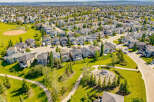 Discover this stunning aerial view of a well-maintained suburban neighborhood, showcasing a variety of modern homes with manicured lawns and mature trees.