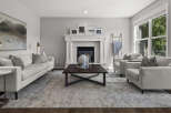 Step into this inviting living room, featuring a cozy fireplace and a large sectional sofa perfect for family gatherings.