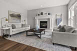 Experience modern comfort in this inviting living room, featuring a sleek fireplace as the focal point.