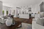 Experience modern living in this stunning open-concept home, featuring a gourmet kitchen with a large island and sleek white cabinetry.