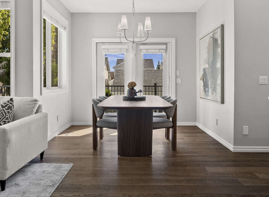 This dining area features a sleek, modern dining table with upholstered chairs, perfect for intimate gatherings.