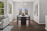 This dining area features a sleek, modern dining table with upholstered chairs, perfect for intimate gatherings.
