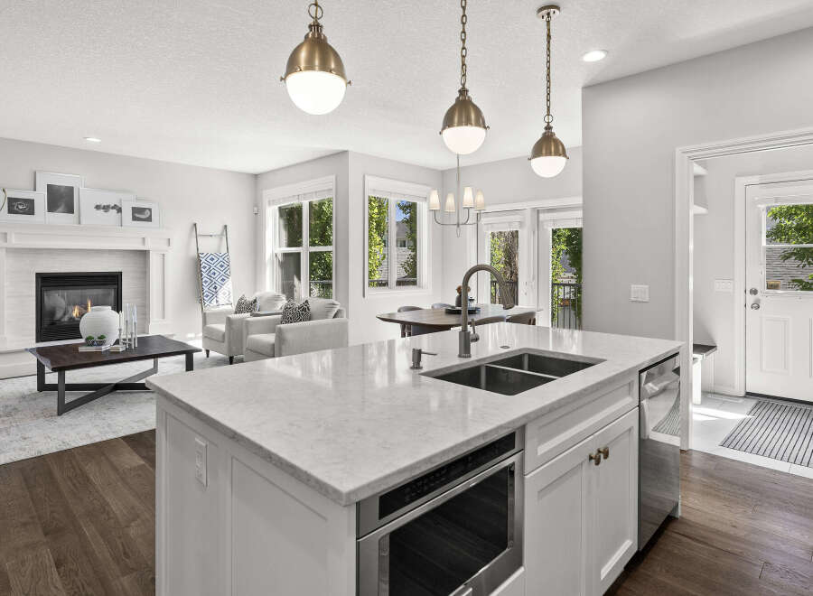 Experience modern living in this open-concept home featuring a gourmet kitchen with a large island, sleek countertops, and stainless steel appliances.
