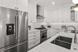 This stunning kitchen boasts sleek stainless steel appliances, including a French door refrigerator and a professional-grade gas range.