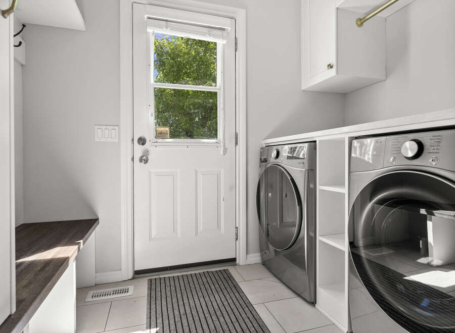 Discover this modern laundry room featuring a sleek LG ThinQ washer and dryer set, perfect for handling all your laundry needs.