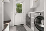 Discover this modern laundry room featuring a sleek LG ThinQ washer and dryer set, perfect for handling all your laundry needs.