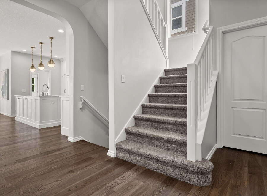Step into this beautifully designed home featuring a modern kitchen with elegant pendant lighting and a spacious island.