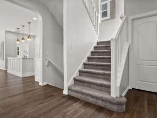 Step into this beautifully designed home featuring a modern kitchen with elegant pendant lighting and a spacious island.