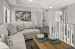 This spacious loft area offers a comfortable sectional sofa perfect for relaxing or entertaining.