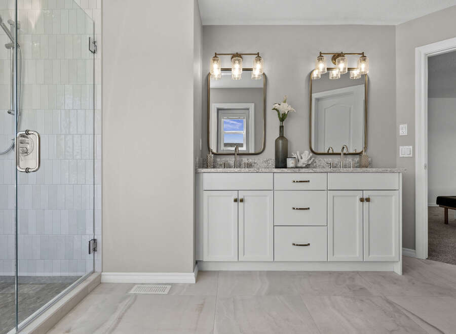 Experience luxury in this stunning bathroom featuring a spacious glass-enclosed shower with elegant tilework.
