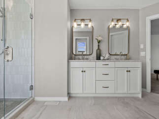 Experience luxury in this stunning bathroom featuring a spacious glass-enclosed shower with elegant tilework.