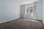 Step into this inviting bedroom, featuring a spacious closet and a large window that floods the room with natural light.