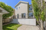 Enjoy outdoor living with this spacious backyard featuring a large deck perfect for entertaining and a lush green lawn.