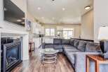 Experience modern living in this spacious open-concept home, featuring a sleek fireplace and a large sectional sofa perfect for gatherings.