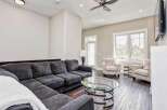 Experience modern living in this spacious living room, featuring a comfortable sectional sofa and two accent chairs adorned with a unique script pattern.