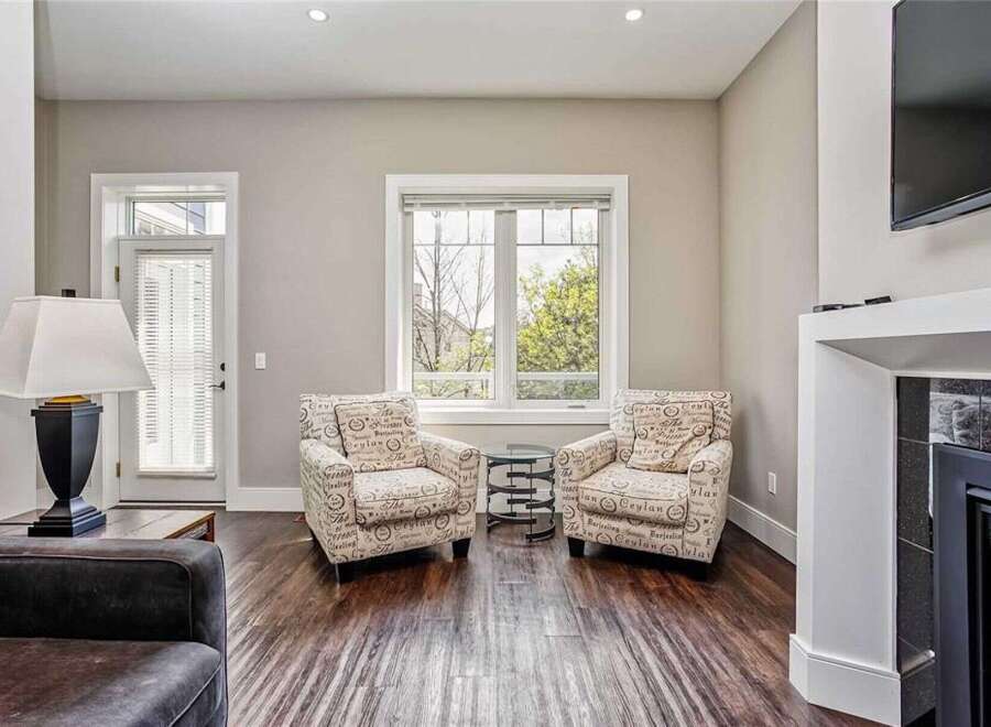 Step into this inviting living space featuring two charming accent chairs with a unique script pattern, perfect for creating a cozy reading nook.