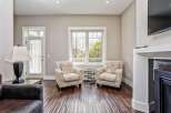 Step into this inviting living space featuring two charming accent chairs with a unique script pattern, perfect for creating a cozy reading nook.