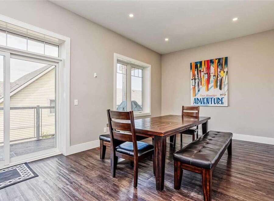 This dining area features a dark wood table with matching chairs and benches, perfect for family meals.