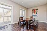 This dining area features a dark wood table with matching chairs and benches, perfect for family meals.