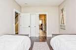 This inviting bedroom features two comfortable beds with crisp white linens, perfect for a restful night's sleep.