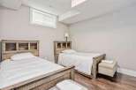 This charming bedroom features two twin beds with rustic wooden headboards, perfect for accommodating guests or family.
