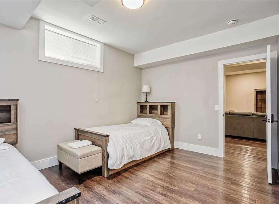This charming bedroom features two cozy twin beds with rustic wooden headboards, perfect for accommodating guests or family.
