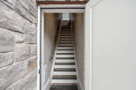 Step into this charming property and be greeted by a well-lit staircase leading to the upper levels.