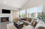 Experience modern living in this spacious living room, featuring a cozy gas fireplace and a large sectional sofa perfect for gatherings.