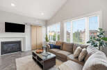 Experience modern living in this spacious living room, featuring a cozy gas fireplace and a large sectional sofa perfect for gatherings.