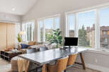 This modern living space features a comfortable sofa and a stylish desk area, perfect for a home office setup.
