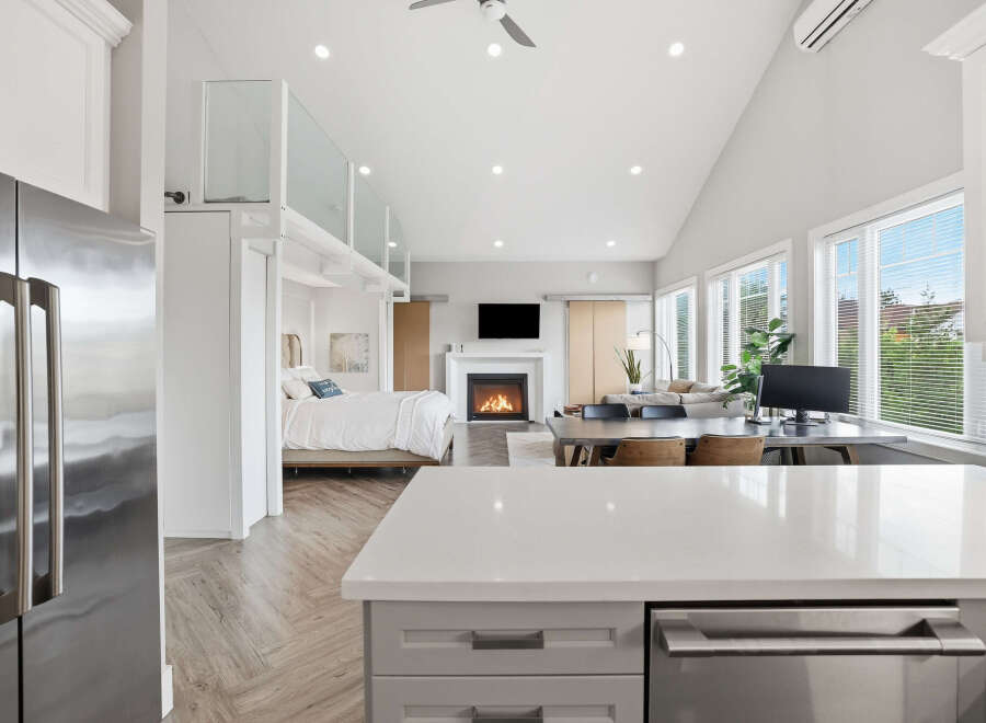 Experience modern living in this stunning open-concept studio, featuring a cozy fireplace and a spacious work-from-home area.