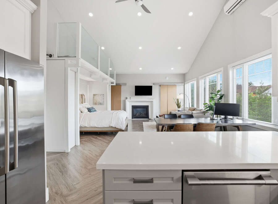 Experience modern living in this stunning open-concept studio, featuring a cozy fireplace and a spacious work-from-home area.