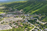 Discover this stunning aerial view of a vibrant mountain resort community, showcasing a blend of residential properties and recreational facilities.