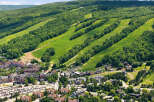 Discover this stunning mountain resort offering a vibrant village with charming architecture and ample parking, nestled at the base of lush, tree-lined ski slopes.