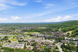 Discover this stunning aerial view of a vibrant mountain resort community, showcasing a mix of charming residential homes and a bustling village center.