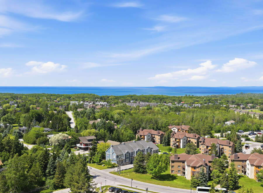 Discover this stunning property offering breathtaking views of the serene blue water and lush green landscape.