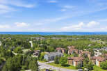 Discover this stunning property offering breathtaking views of the serene blue water and lush green landscape.
