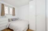 Discover this cozy bedroom featuring a comfortable bed with neutral bedding and accent pillows.